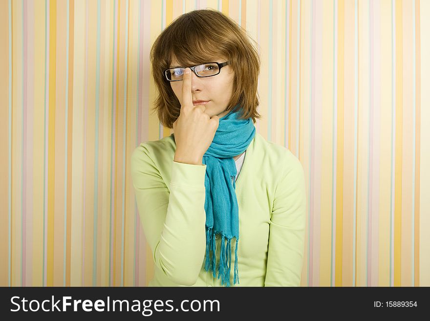 Beautiful young woman in glasses. Correcting glasses. Beautiful young woman in glasses. Correcting glasses