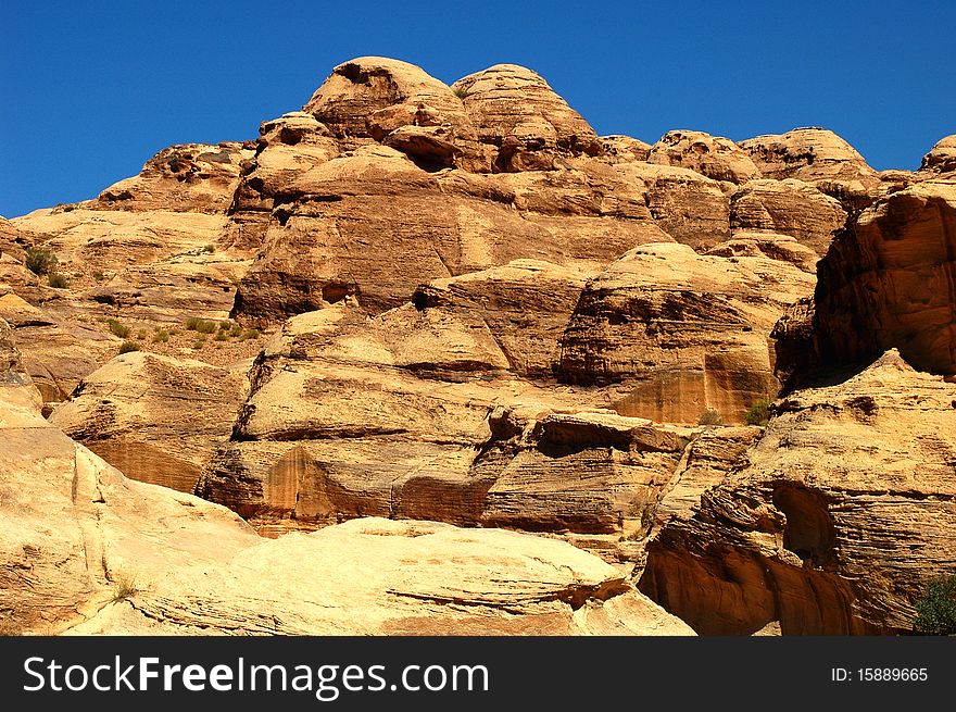 Scenery of huge rocks and cliffs of mountains with blue skies as backgrounds