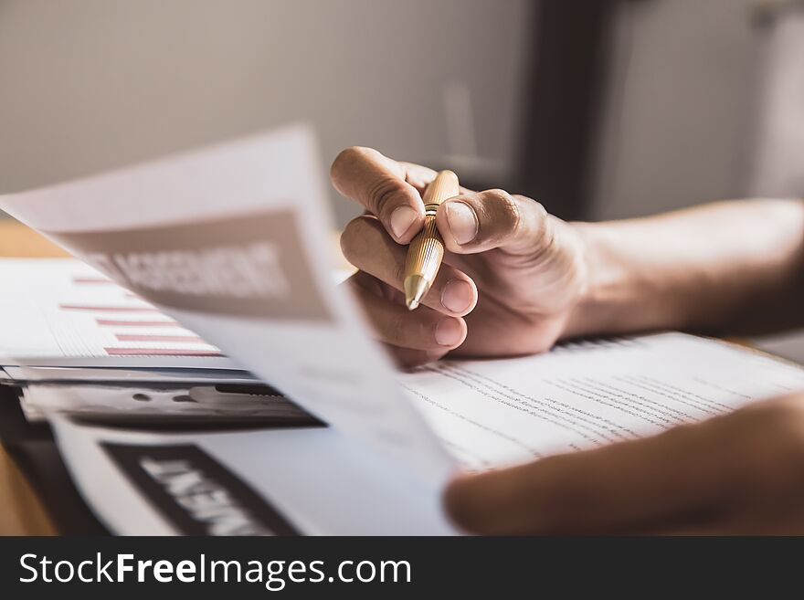 Businessman or lawyers sitting office signing contract papers on wood table. Law of advisor Concepts and vintage, Sunset light.