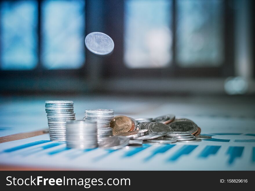 Silver coins placed and bank note on desk with light sunset instagram style filter photo vintage tone