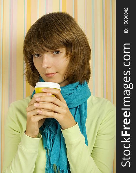 Young girl in a room with a paper cup of coffee. Young girl in a room with a paper cup of coffee