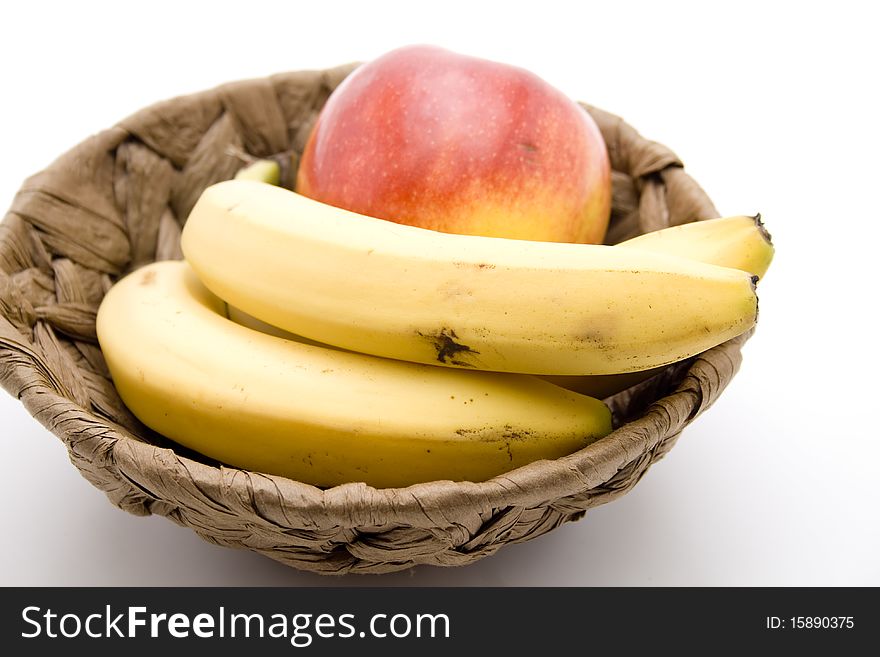 Refine ripe bananas and apple in the basket
