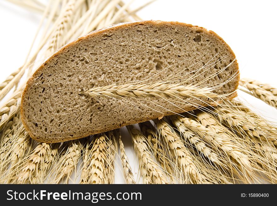 Cut bread and with wheat ears. Cut bread and with wheat ears