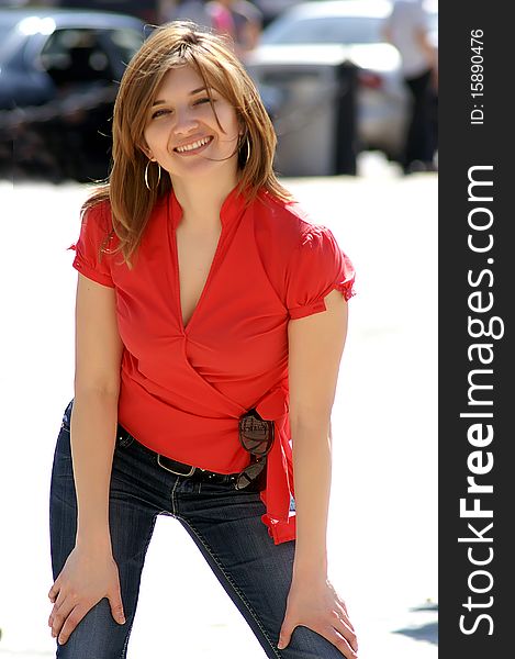 The beautiful young girl in a red blouse