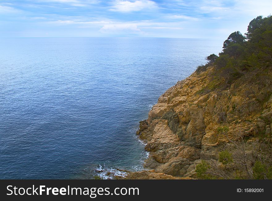 Rocky cliff on the blue sea