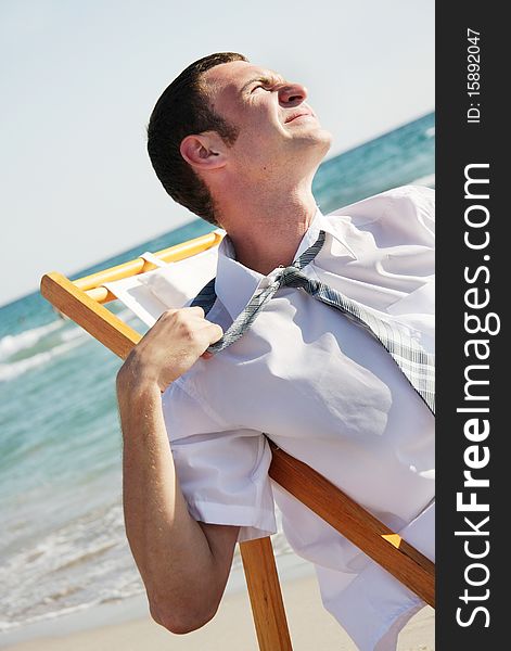 Tired businessman on sea background