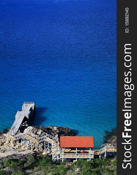 A beautiful view of the jetty and the blue sea from top of the hill. Location - Perhentian Island, Malaysia. A beautiful view of the jetty and the blue sea from top of the hill. Location - Perhentian Island, Malaysia.