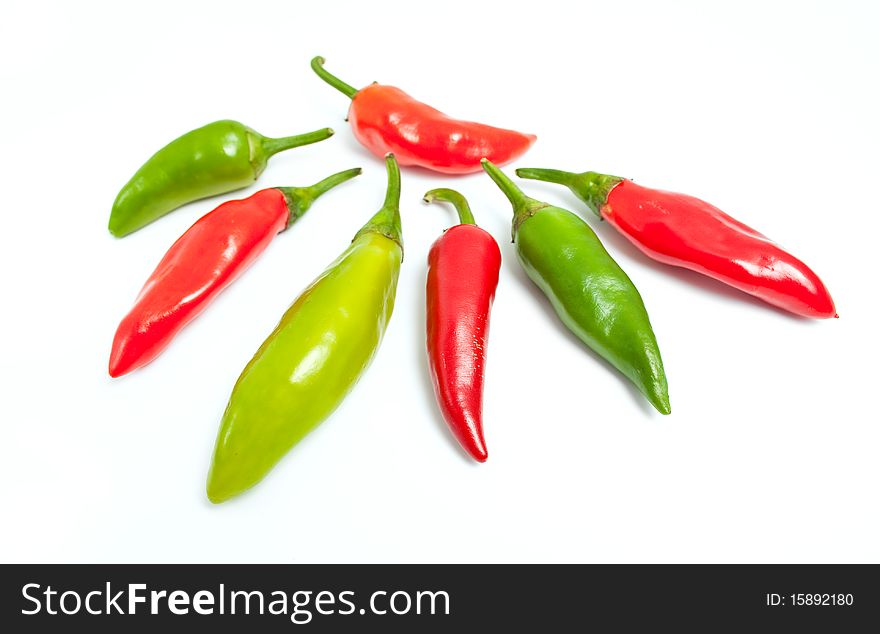 Green and red hot peppers isolated on white background