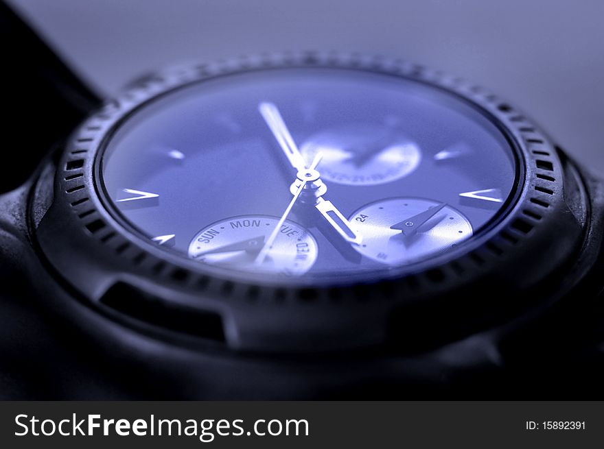 Detail of watch face with numbers and hands showing time. Detail of watch face with numbers and hands showing time