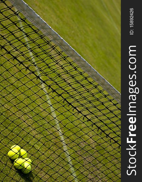 Perspective view of tennis net and grass court. Perspective view of tennis net and grass court.