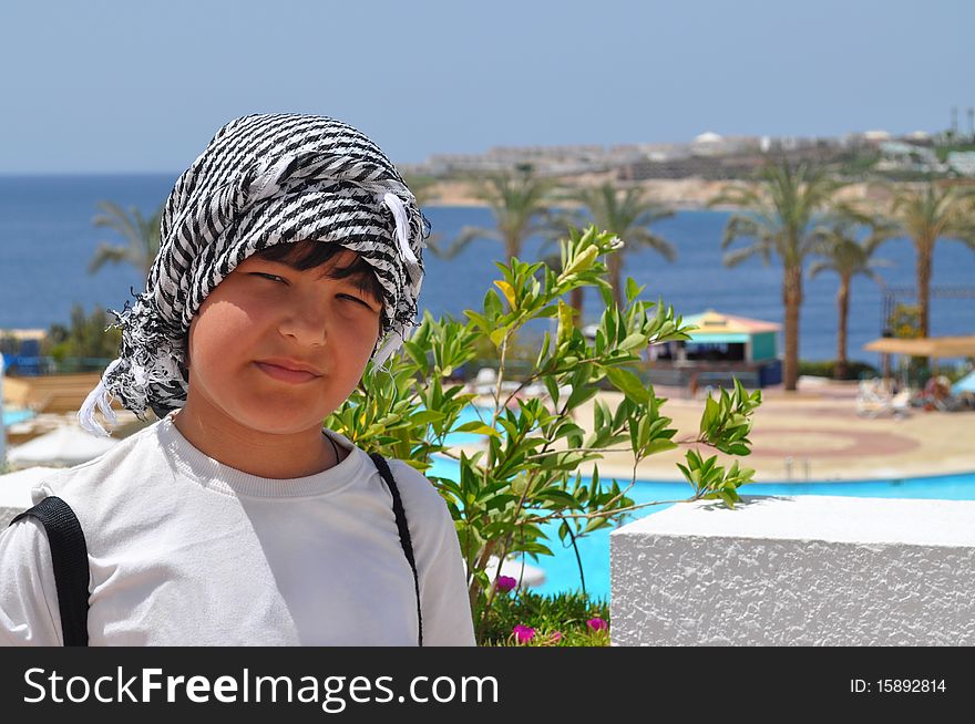 Boy in the Arab headdress under the rays of bright sunshine. Boy in the Arab headdress under the rays of bright sunshine