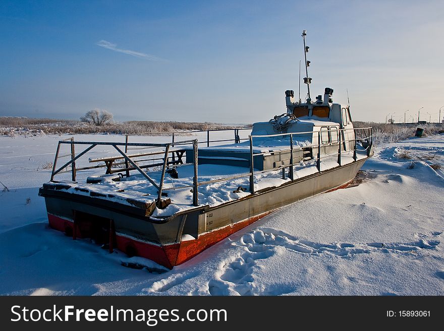 Frozen old boat on ground