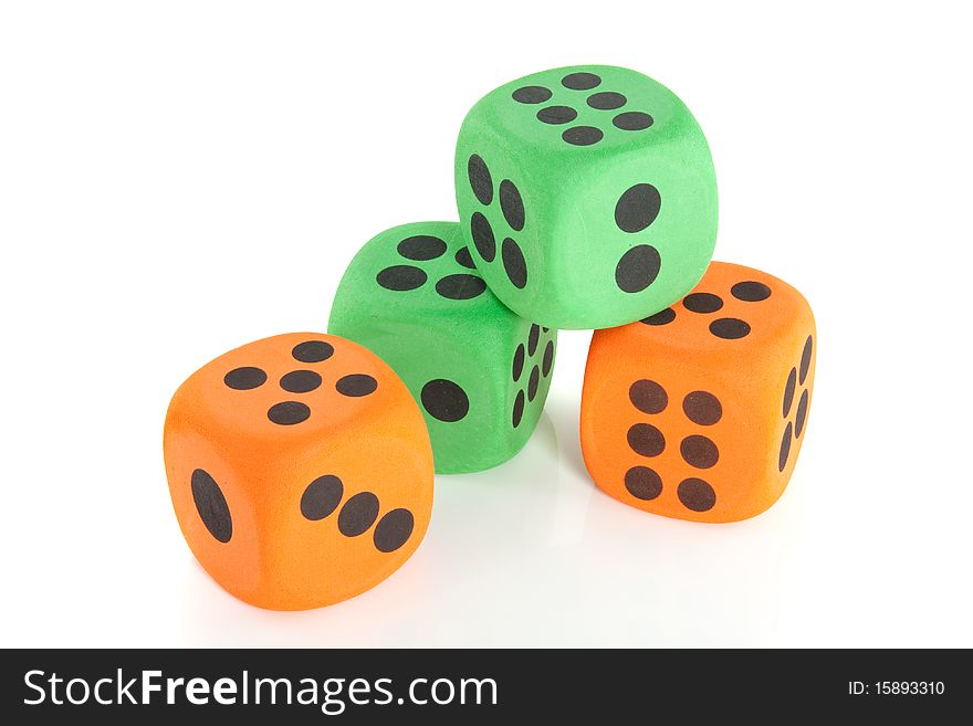 Colorful green and orange stacked dice isolated over white