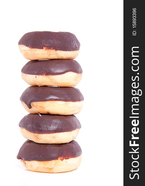 Five stacked chocolate donuts isolated over white