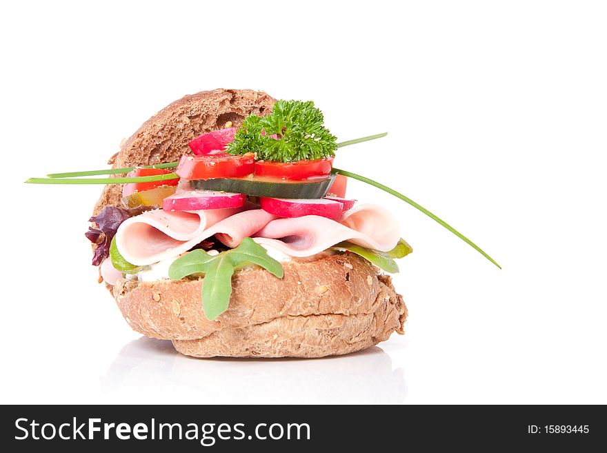 A healthy sandwich with colorful vegetables isolated over white