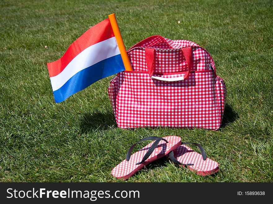 The Dutch Flag in a travelbag on a green lawn