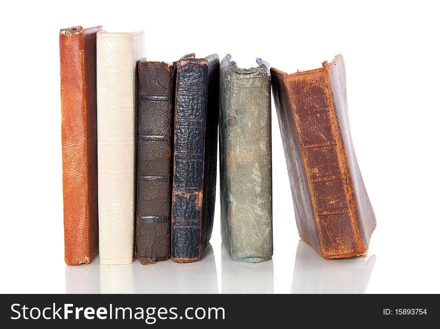 Very old books abreast isolated over white