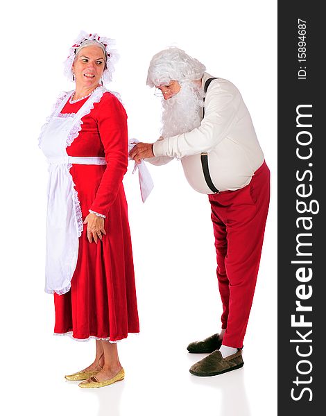 Santa Claus tying Mrs. Santa's apron while she looks on. Isolated on white. Santa Claus tying Mrs. Santa's apron while she looks on. Isolated on white.