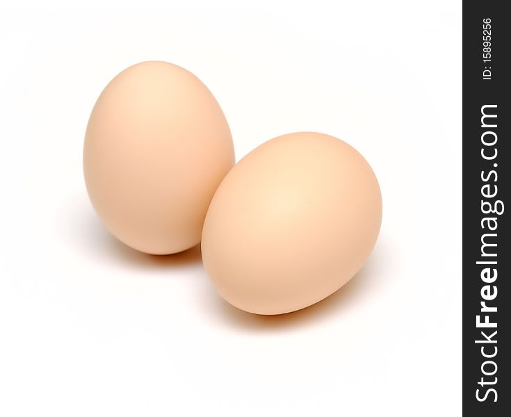 Two brown eggs isolated on white