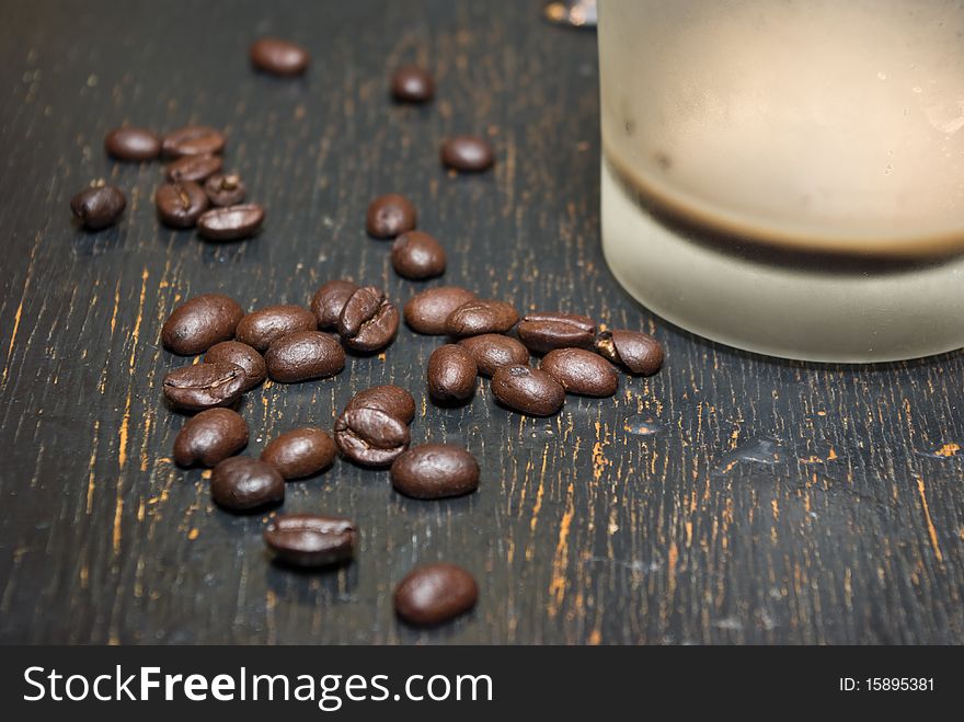 Lie Emptied of a cup of coffee and coffee beans. Lie Emptied of a cup of coffee and coffee beans