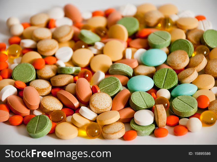 Heap of pills isolated as a background