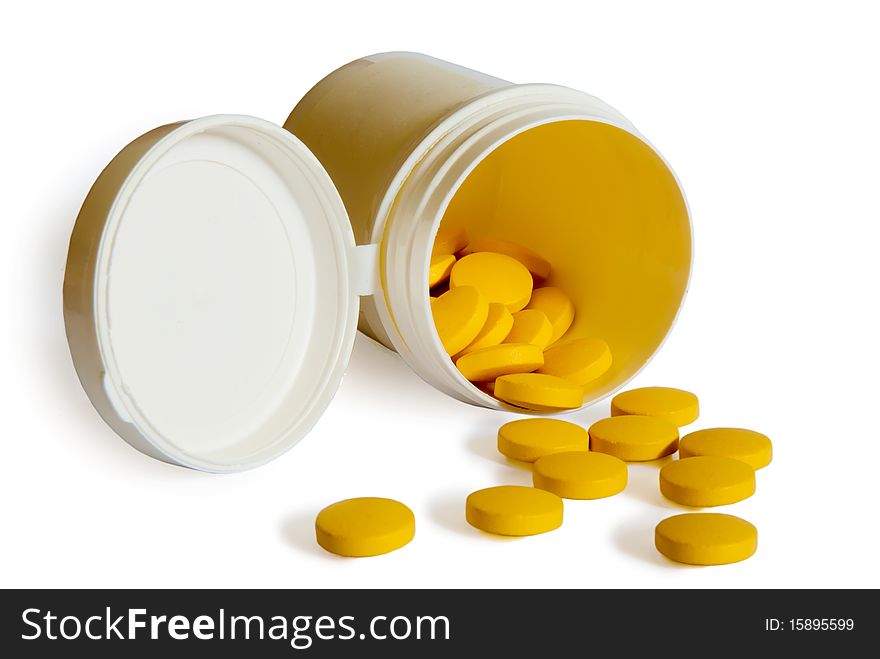 Yellow pills with container isolated on white