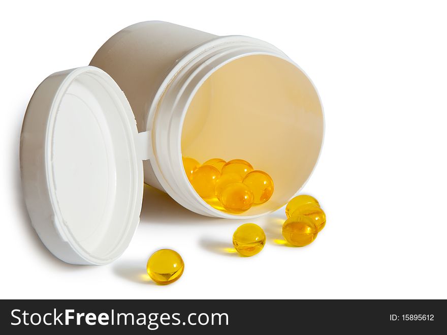 Yellow pills with container isolated on white