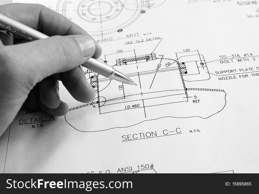 Hand of engineer drawing technical document. Hand of engineer drawing technical document.