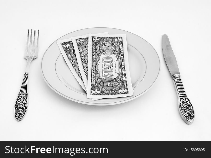 Dinner service with dollar denominations on plate. Dinner service with dollar denominations on plate.