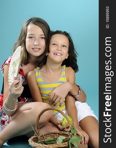 Two girls playing with green apples. Two girls playing with green apples