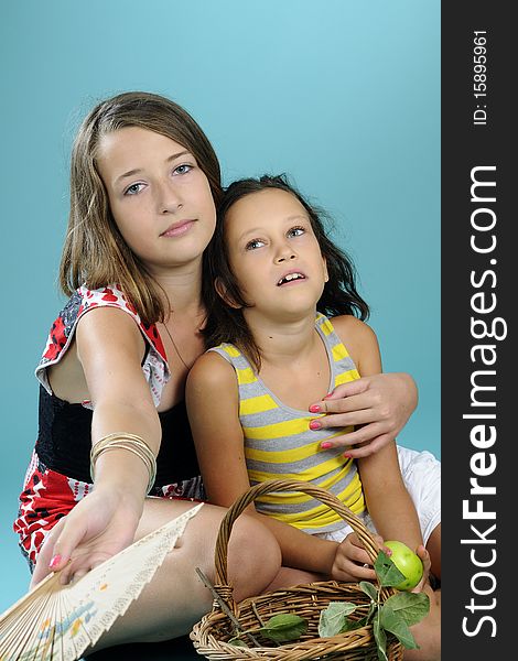 Two girls playing with green apples. Two girls playing with green apples