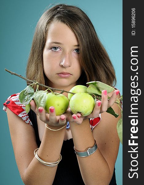 White teenager showing green apples in studio. White teenager showing green apples in studio