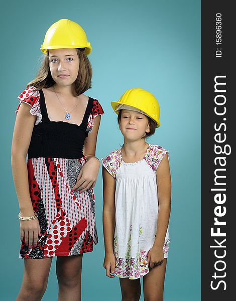 Two beautiful children showing yellow construction equipments. Two beautiful children showing yellow construction equipments