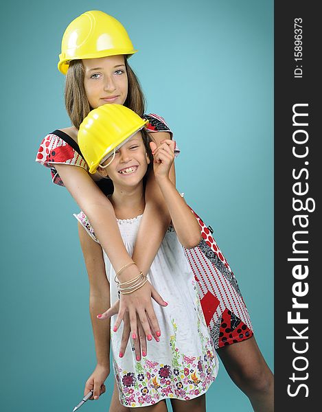 Two beautiful children showing yellow construction equipments. Two beautiful children showing yellow construction equipments