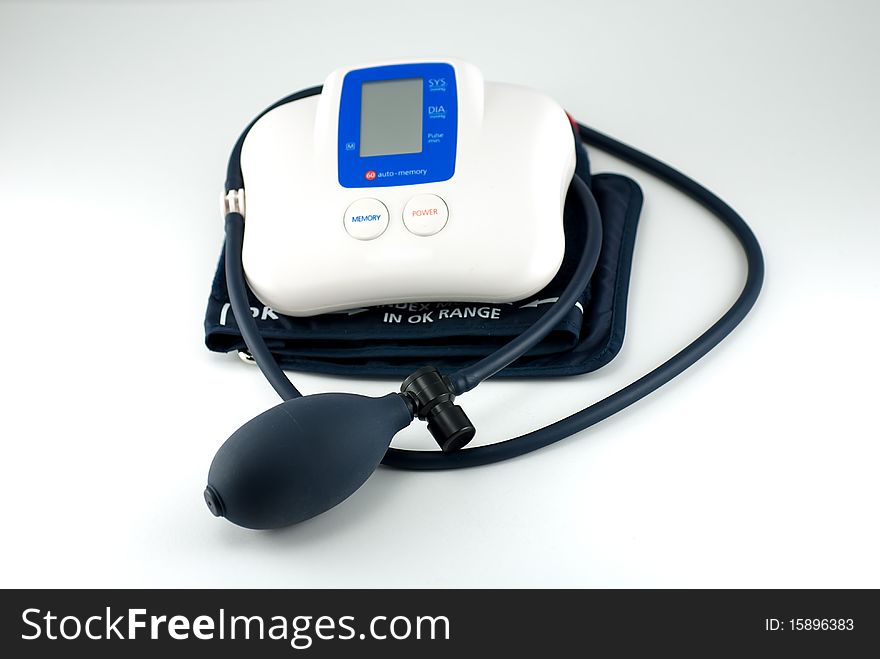 Digital blood pressure gauge on white background