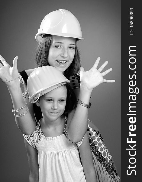 Two beautiful children showing yellow construction equipments. Two beautiful children showing yellow construction equipments
