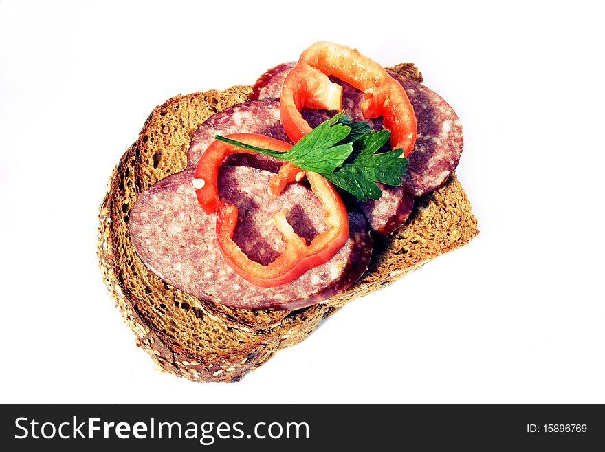 Sandwich with fresh rye bread, sausage, pepper and greens. Sandwich with fresh rye bread, sausage, pepper and greens