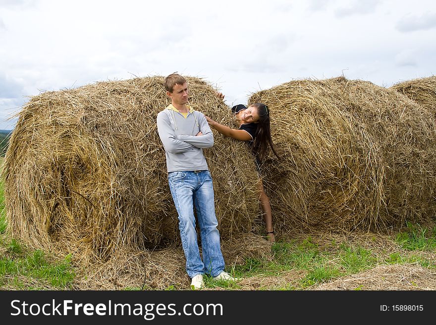 Young couple costs about a haystack