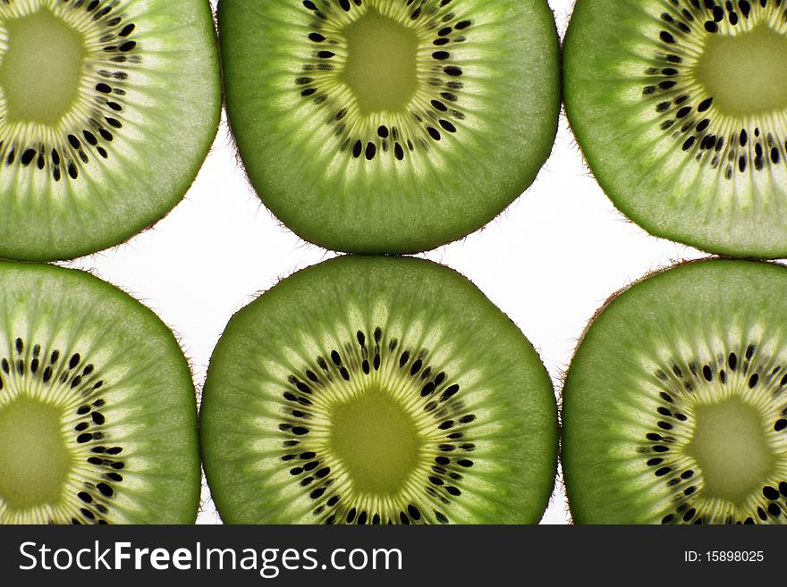 Segments of fruit of a kiwi on a white background