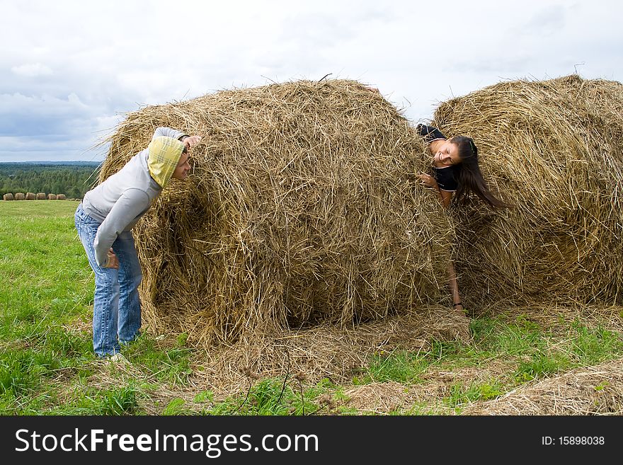 Young couple costs about a haystack