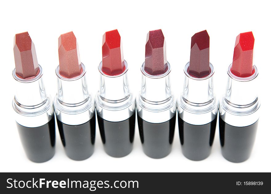 Lipstick stands in row on white background