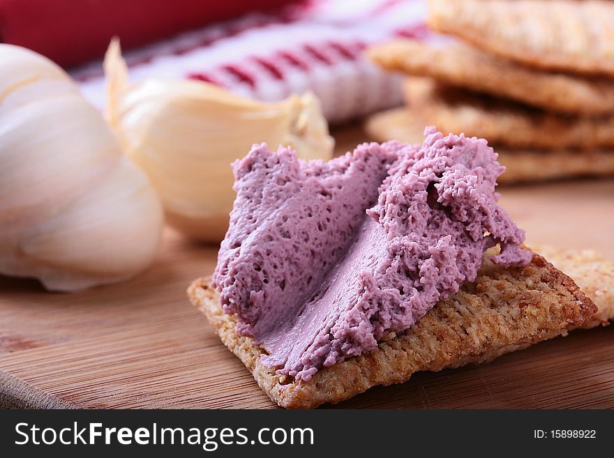 Wheat crackers on a kitchen board with whipped cream.