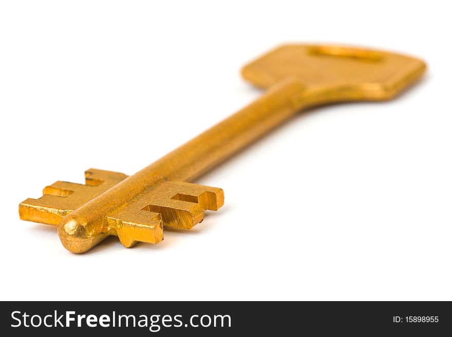 Macro of retro gold key isolated on white background