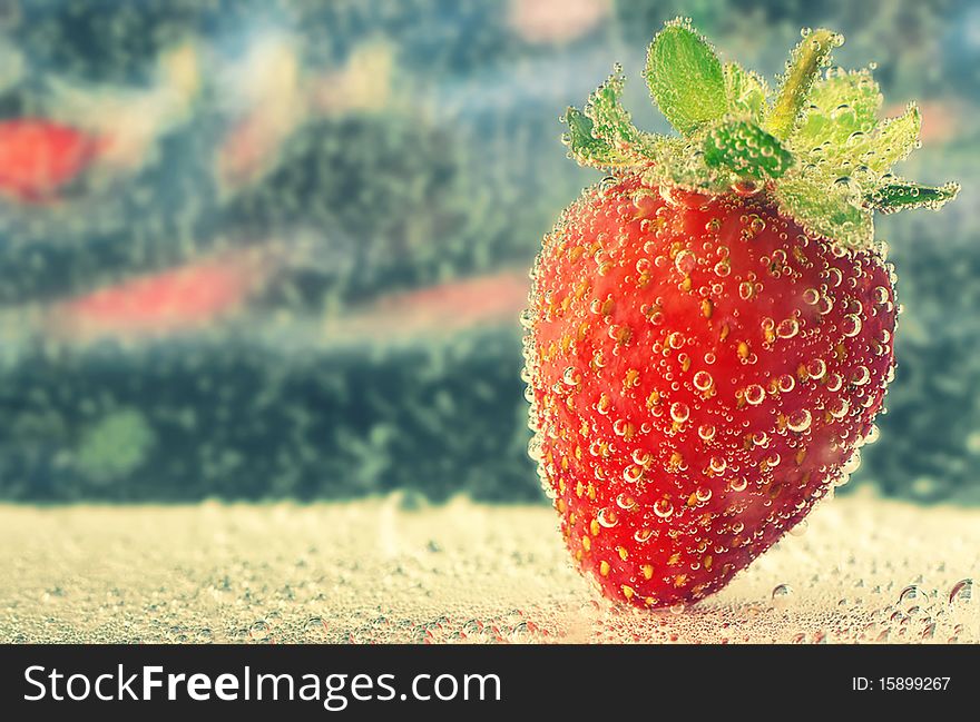 Red juicy strawberry in water