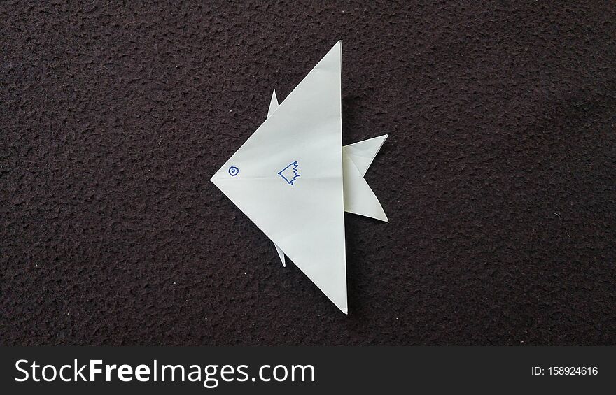 Top view of White fish origami drwan with face