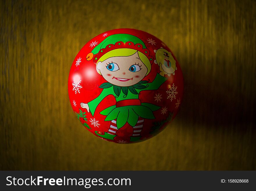 A closeup shot of an elf Christmas tree ornament on a wooden surface