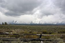 Fenceline And Cloudy Grand Tetons Stock Photography