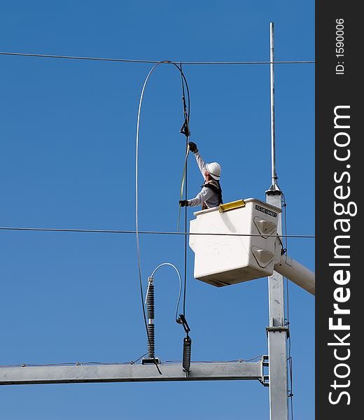 Lineman installing powerlines at a new substation.