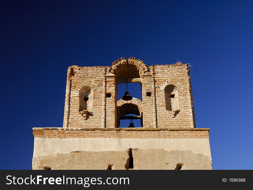 Tumacacori Mission Bell Tower against a blue sky in Arizona