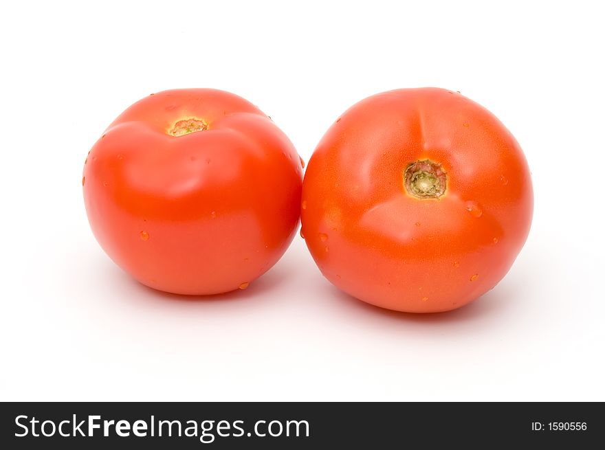 Two tomatoes on the white